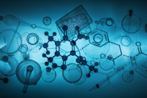 flasks and model molecules back lit with a blue hue and darkness around the edges