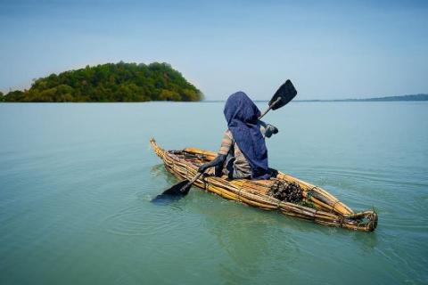 Cover photo of the lake with islands and a fisher on papyrus made boat