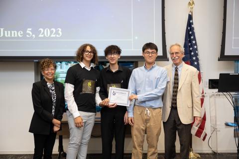 David Minn, Brian Guzman, and Kayleb Hernandez receiving their 3rd place overall award certificate