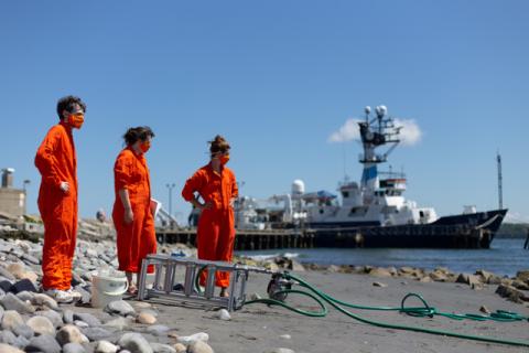 students on a beach sampling for microplastics