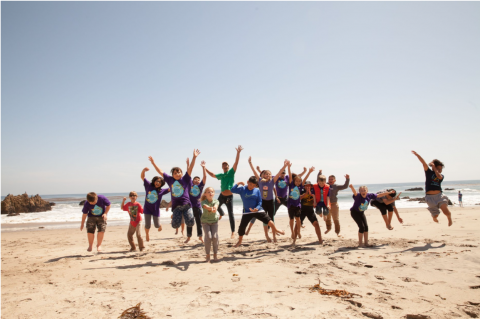 Group of people jumping on a beach