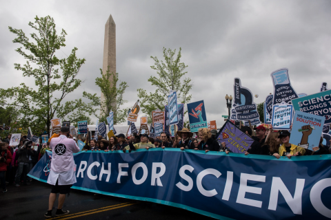 Activist scientists in Washington DC at the 2017 March for Science holding a March for Science Banner