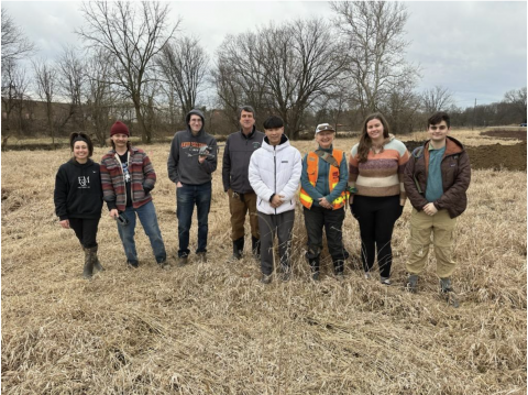 Students standing together in a field