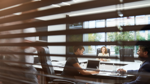 people meeting seen through blinds