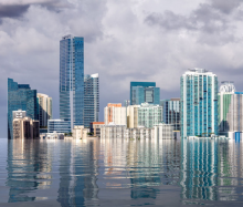 A city with skyscrapers that appears to be partly underwater due to predicted sea level rise