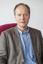 Jean-François Soussana's headshot. he is smiling and wearing a tan suit jacket with a blue shirt